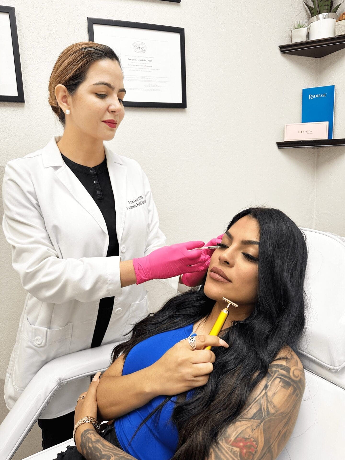 Dermatologist Applying Botox Cosmetics Facial Treatment On Patient Holding A Facial Roller To Her Face