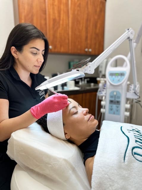 Specialist performing an acne treatment with professional equipment at Danik MedSpa