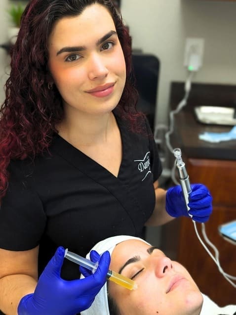 Specialist performing microneedling on a client at Danik MedSpa