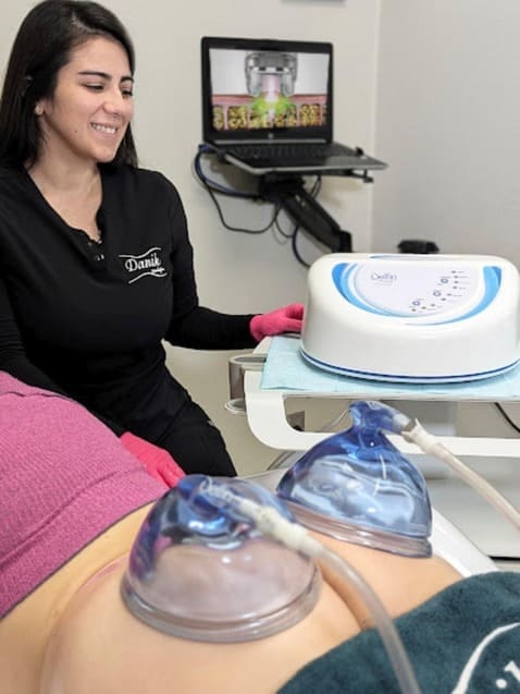 Specialist using vacuum therapy cups on a client at Danik MedSpa.